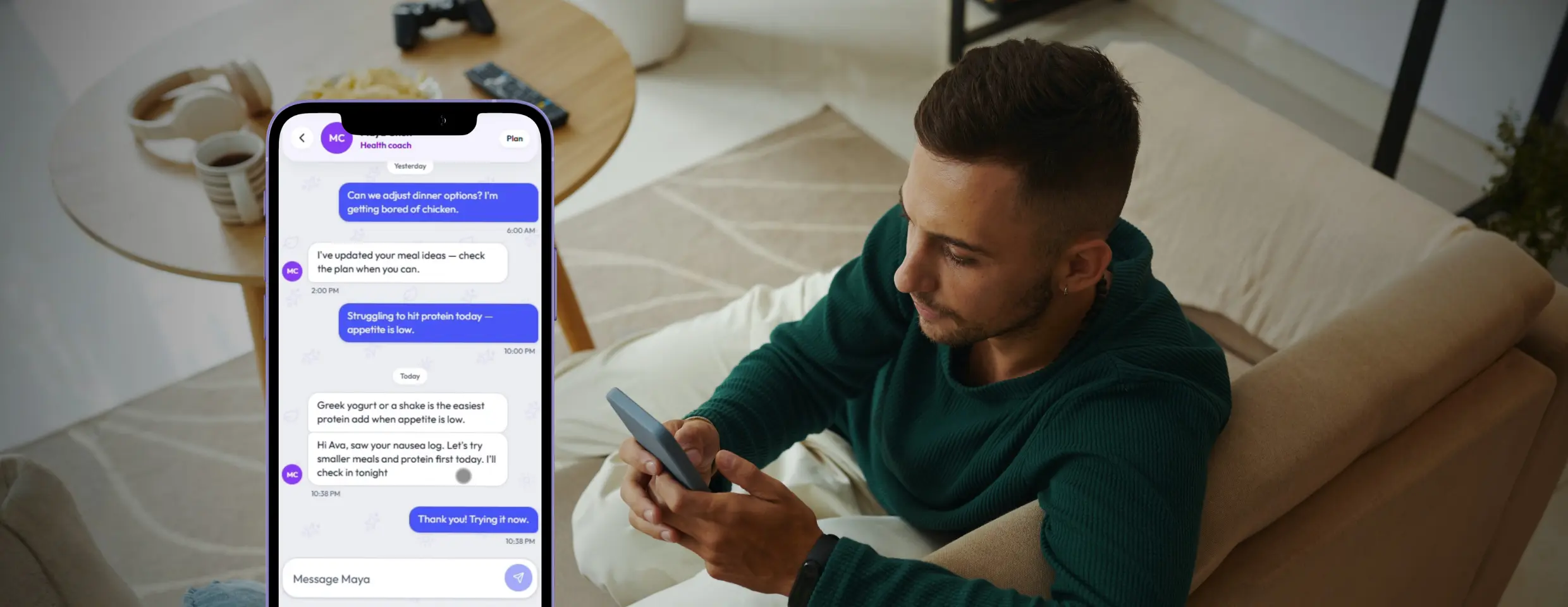 A man on his sofa messaging his health coach about nausea on his phone